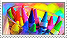 A color stamp of several crayons in a glass cup.