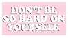 A pink stamp with white text that reads in capital letters, 'Don't be so hard on yourself'