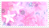 A stamp with several pink sparkles and star-shaped glitter